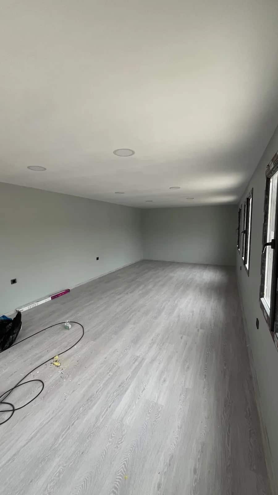 Geniş salonda gri laminat parke döşeme